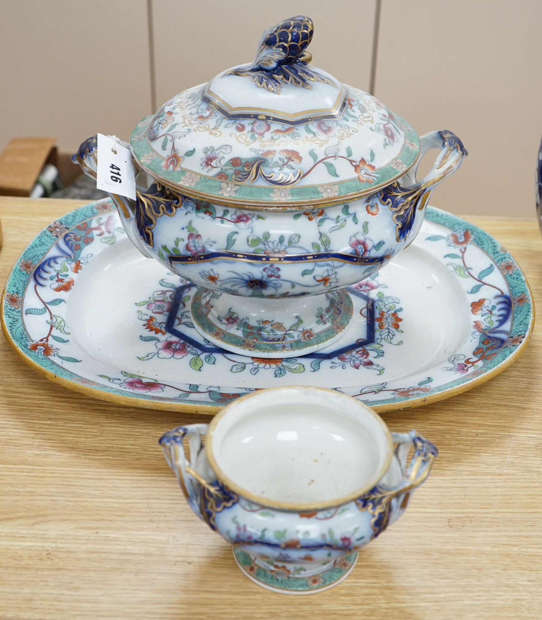 A mid 19th century Staffordshire pottery lidded soup tureen and cover (base cracked), a large meat dish and a sauce tureen (lacking lid) (3)